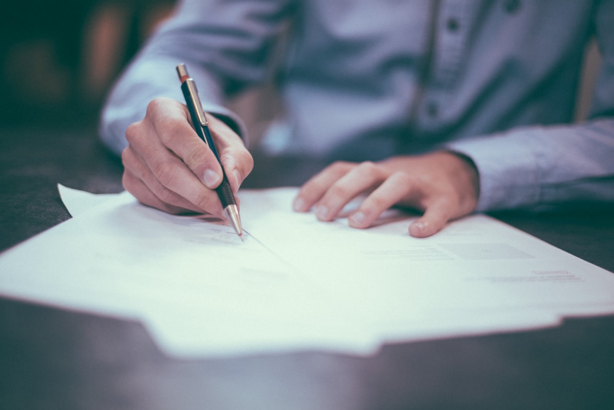 Hands filling out a written condition report